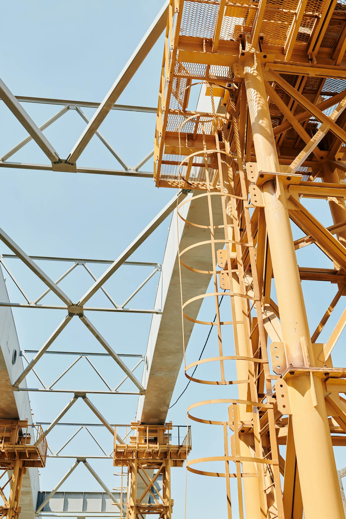 Steel structures and scaffolding on a clear day at a construction site.